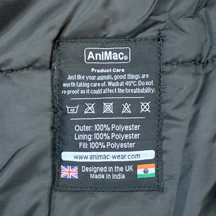 A black AniMac label on the Super Calf Jacket | Waterproof lists care instructions, fabric composition, washing symbols, company website, and features UK and India flags to show it's designed in the UK and made in India.