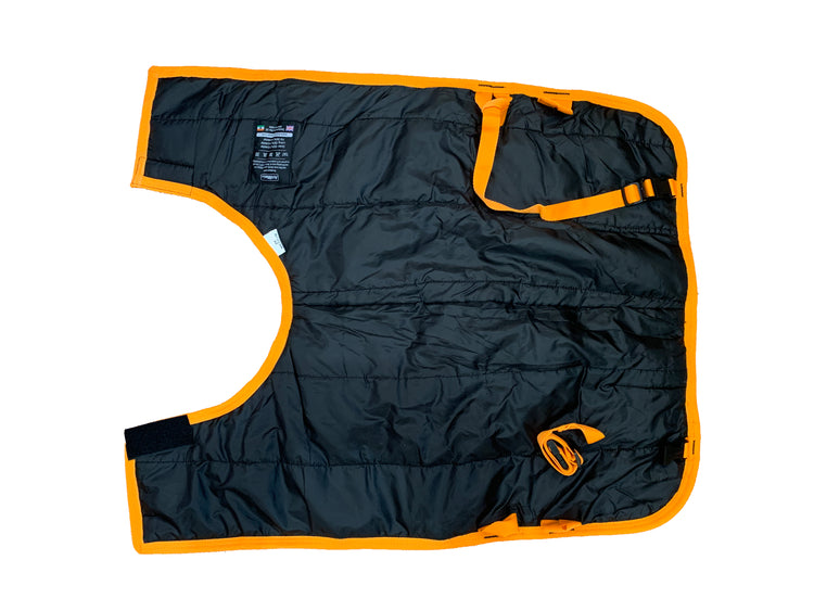 The Super Calf Jacket | Waterproof features black quilted fabric with bright orange trim and adjustable straps, shown laid flat on a white background—perfect for keeping newborn calves warm.