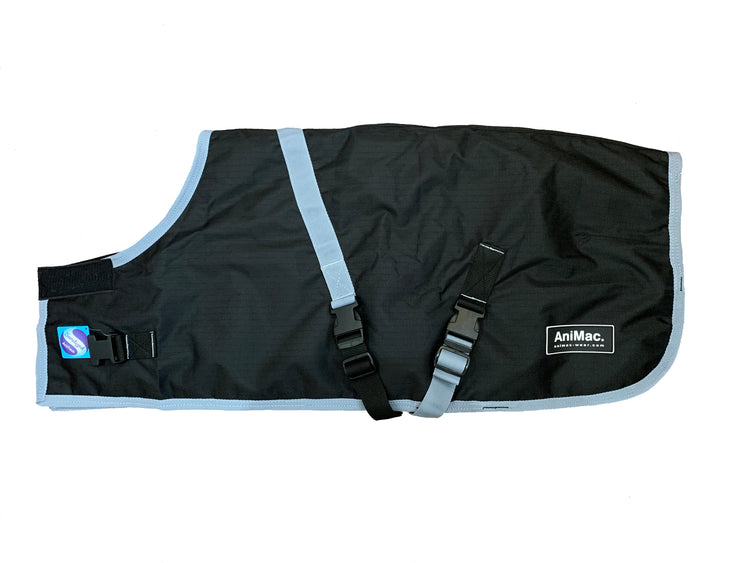The Goat Coat | Waterproof is a black and gray adjustable blanket with clips and straps for securing, featuring the AniMac brand label and a colorful logo patch on the left side.