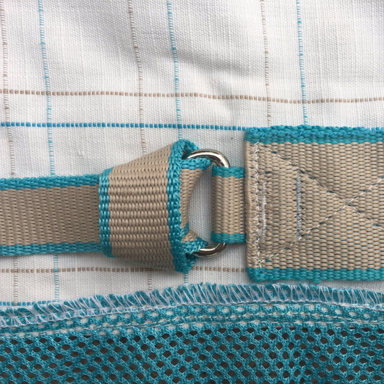 Close-up of beige and turquoise webbing strap threaded through a metal D-ring, attached to the AniMac Allrounder Fly Rug Combo with breathable blue mesh and white fabric featuring a subtle blue and beige grid pattern.