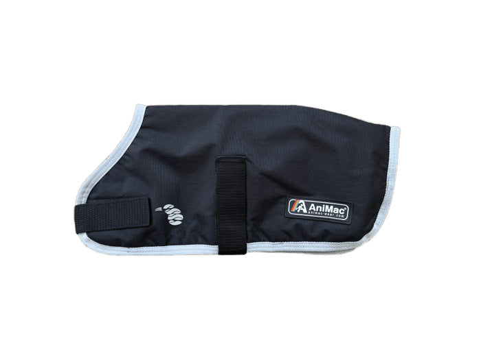 The Alpaca Coat | Waterproof in black and gray features a light trim, Velcro strap, and AniMac Pets logo label on the side, shown laid flat on a white background.